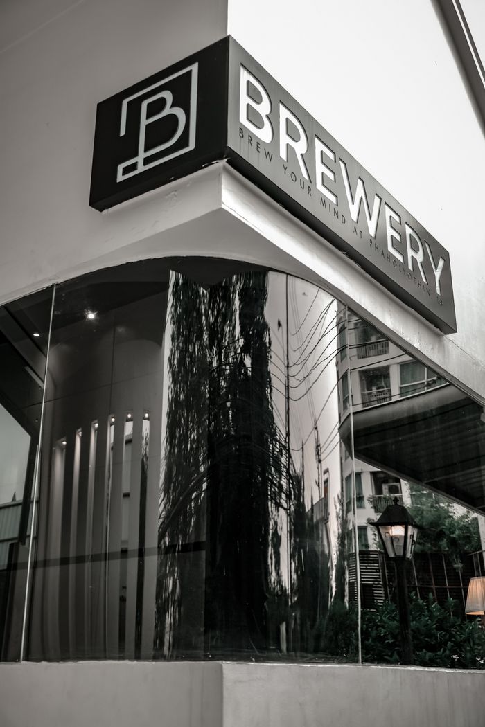 Contemporary brewery facade featuring mirrored windows and bold signage.